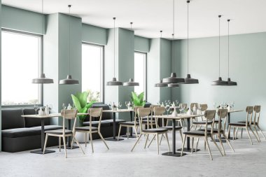 Gri yeşil duvarlar, büyük pencereler, bir beton zemin ve kanepeler ile kare tablolar ile modern bir kafe köşesinde. 3D render sahte kadar yakın çekim