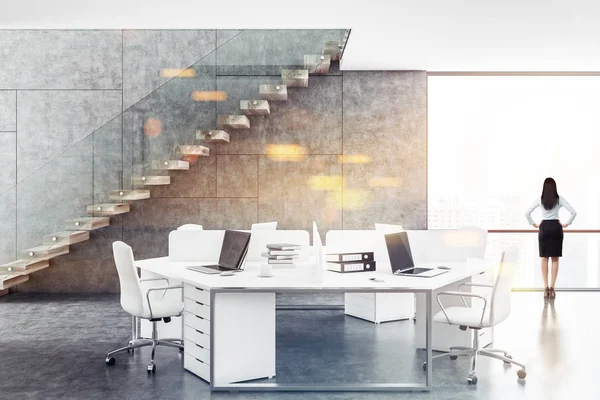 Businesswoman in a concrete and white walls office interior with a concrete floor, loft windows, a staircase and white computer tables. 3d rendering mock up toned image double exposure