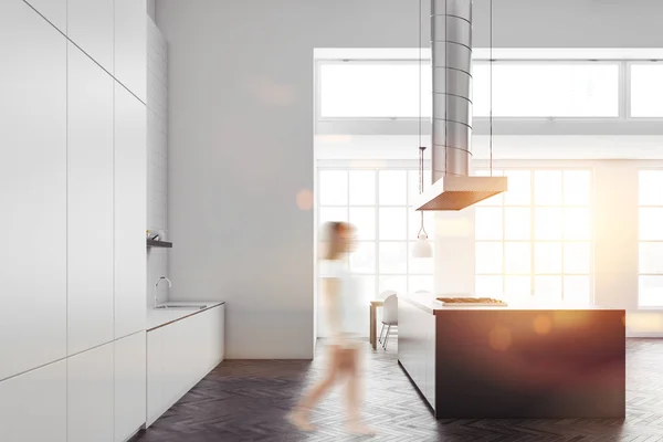Woman walking in an Industrial style kitchen interior with gray countertops, white walls and a concrete floor. Side view 3d rendering mock up toned image double exposure blurred