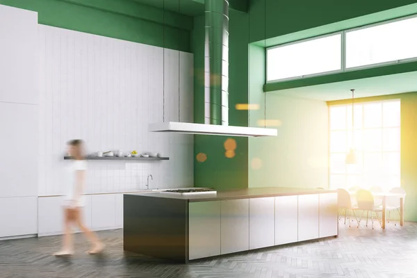 Woman walking in an Industrial style kitchen interior with gray countertops, white and green walls and a concrete floor. Side view 3d rendering mock up toned image double exposure blurred