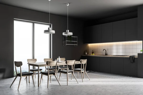 侧面视图的简约厨房与黑色的墙壁 混凝土地板 一张桌子 椅子和黑色台面 — 图库照片