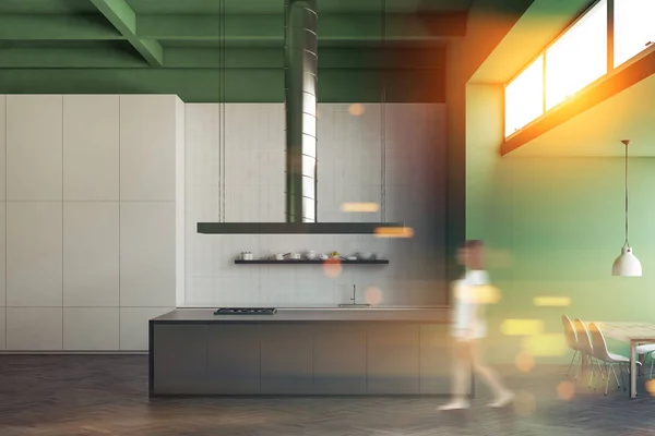 Woman walking in an Industrial style kitchen interior with gray countertops, white and green walls and a concrete floor. 3d rendering mock up toned image double exposure blurred