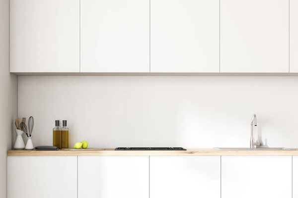 Белые кухонные прилавки с котелком, посудой и бутылками на них. Над ним висит ряд шкафов в белой комнате. Закрывай. 3D рендеринг макет
