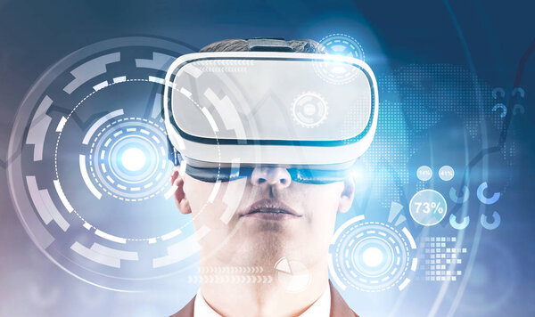 Young businessman in VR glasses. HUD interface and infographics foreground. Hi tech innovation communication global world concept. Toned image double exposure Elements of this image furnished by NASA