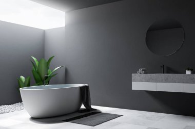 Büyük banyo köşesi Gri duvarlar, kiremitli bir zemin, yuvarlak ayna ile bir lavabo ve küvet. 3D render alay