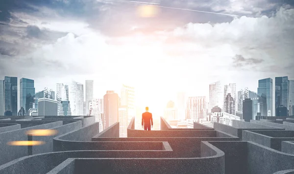 Businessman figure leaving a gray maze and going into a city at dawn. Concept of hope and solution search in business and life. Finding your way. Toned image double exposure mock up