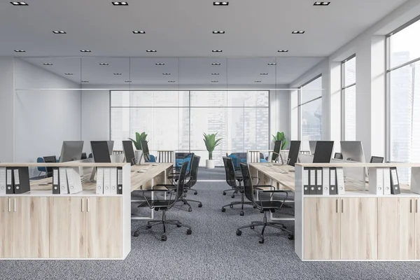 Startup office corner with a gray carpet and rows of white computer tables. Industrial style interior with white walls and large windows with a cityscape. Front view. 3d rendering mock up