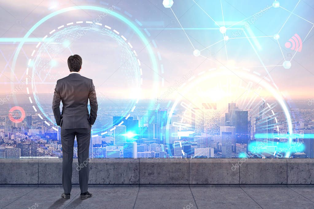 Rear view of businessman standing on balcony looking at futuristic glowing icons. Abstract HUD and infograph in city sky. Toned image double exposure mock up Elements of this image furnished by NASA