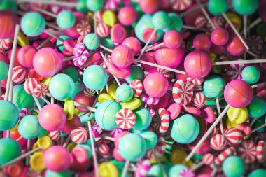 Colorful yellow, blue and pink lollipops background. Concept of little joys, guilty pleasures and sweets addiction. 3d rendering mock up clipart
