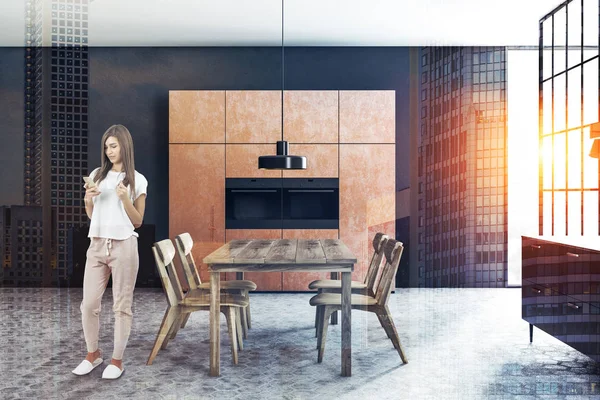 Woman in a black wall dining room interior with a tiled floor, brown closets, black countertops and a wooden table with chairs. 3d rendering toned image double exposure city side view