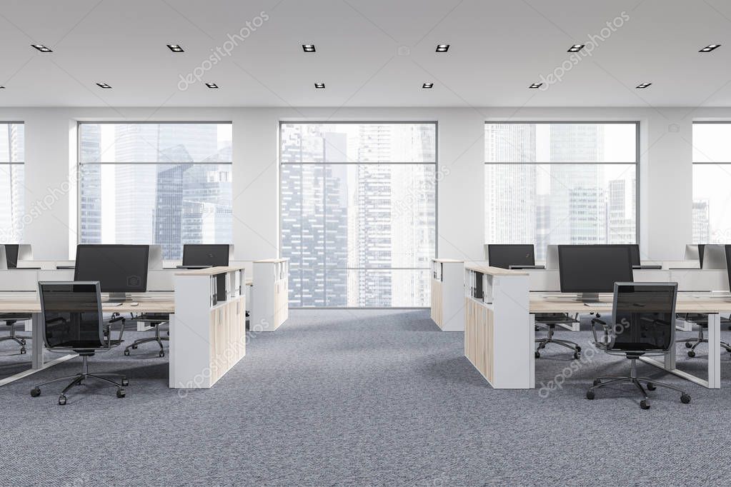 Company office corner with a gray carpet and rows of white computer desks. Industrial style interior with white walls and large windows with a cityscape. Front view. 3d rendering mock up