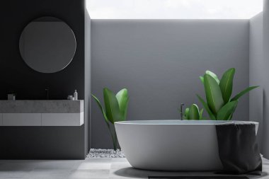 Bir büyük banyo iç Gri duvarlar, kiremitli bir zemin, yuvarlak ayna ile bir lavabo ve küvet ile önden görünümü. 3D render alay