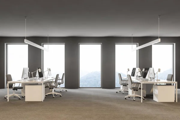 Side view of modern grey office interior with rows of white computer desks and loft windows. International company concept 3d rendering copy space