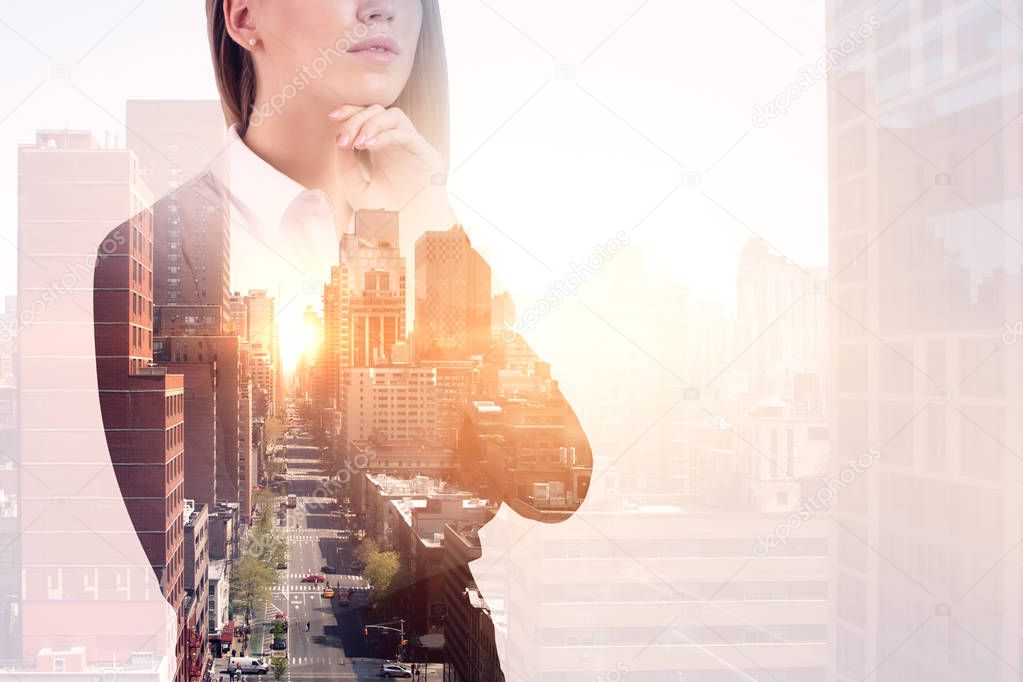 Unrecognizable young businesswoman standing over a morning cityscape background. Business lifestyle concept. Toned image double exposure copy space