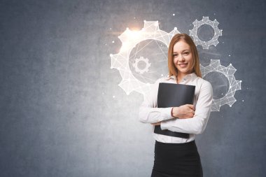 Genç işkadını klasör ayakta cogwheels ve dişli ile beton duvara yakın üzerinde sarılma gülümseyerek. Ekip çalışması kavramı. Resim sahte tonda