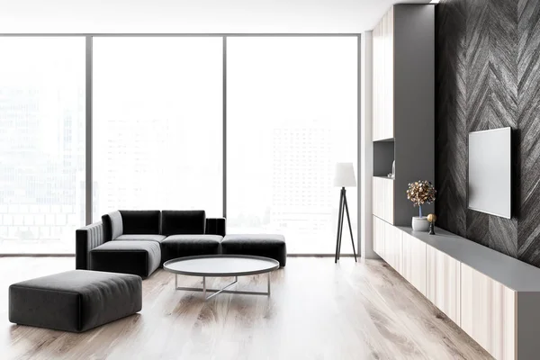 Side view of loft living room with wooden floor and black wooden walls, a sofa and a round coffee table. Flat screen TV set. 3d rendering mock up