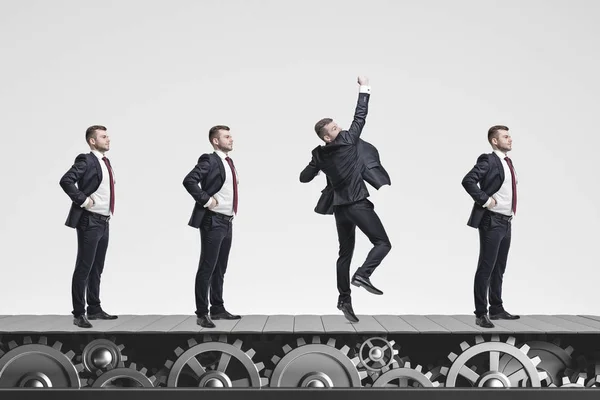 Side View Businessmen Clones Standing Conveyor Belt One Them Jumping — Stock Photo, Image