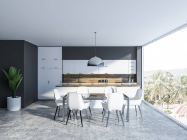 Gri duvarlar, beton zemin, tropik manzaralı panoramik pencere, cam masa beyaz sandalye ve arka planda bir mutfak ile yemek odası iç. 3D render kopya alanı