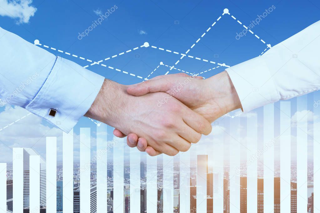 Close up of two businessmen shaking hands over a cityscape background. Graph and diagrams in the foreground. Sealing a deal and corporate lifesyle concept. Toned image double exposure