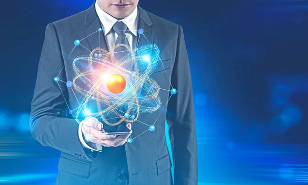 Unrecognizable Businessman Holding His Smartphone Glowing Atom Model Dark Blue — Stock Photo, Image
