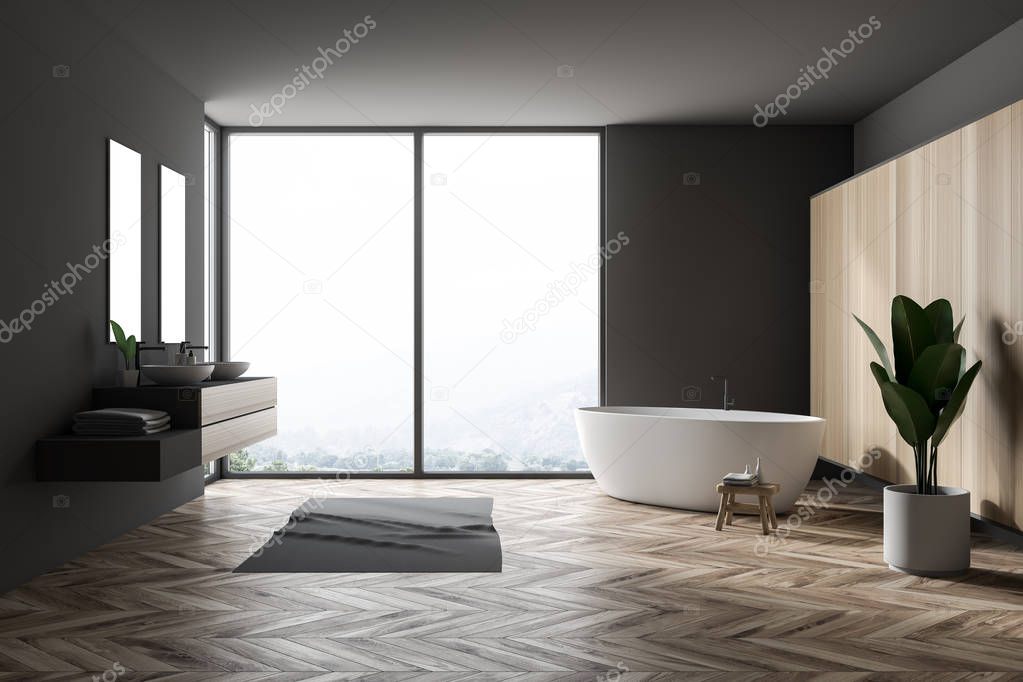 Stylish gray bathroom interior with wooden floor, gray rug, window with forest view, wooden wall, big bathtub, double sink with vertical mirrors and a potted plant. 3d rendering copy space