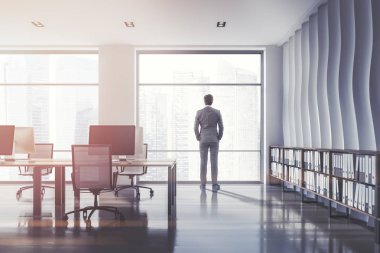 Onlara klasörlerle açık plan ofis iç dalga desen duvar, ahşap döşeme zemin, metalik sandalye ve raf ile bilgisayar tabloları satırları penceresinde arıyorum takım elbiseli adam. Tonlu görüntü