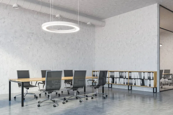 Industrial style board room interior with concrete walls and floor, a wooden table and metal chairs. Round ceiling lamp and pipes. 3d rendering copy space