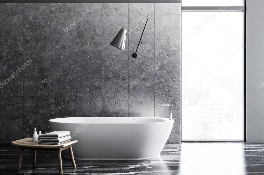 Industrial style bathroom interior with concrete walls, a black marble floor, a white bathtub and a table with towels. 3d rendering copy space