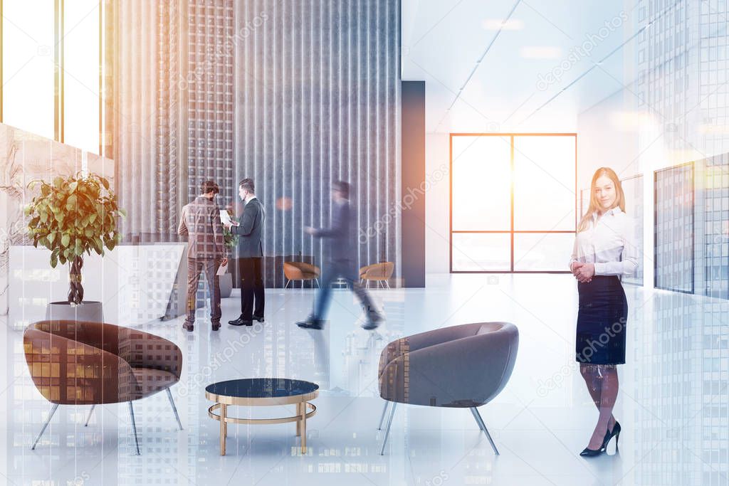 Busienss people in office reception area with long reception table, gray and marble walls, panoramic windows and leather armchairs near neat round coffee tables. Toned image double exposure blur