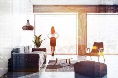 Beyaz mermer Vitrinlere bakıyor işkadını oturma odası iç beton zemin, gri li, siyah koltuklar ile çatı ve sehpa yuvarlak. Çift tonlu görüntü pozlaması