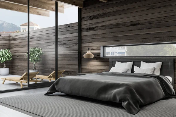 Corner of stylish bedroom with dark wooden walls, concrete floor, gray master bed and neat bedside tables. 3d rendering