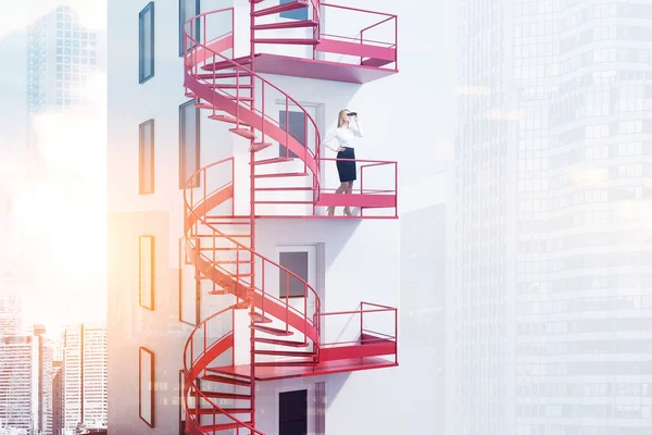 Blonde Businesswoman Binoculars Standing Spiral Red Emergency Exit Staircase White — Stock Photo, Image