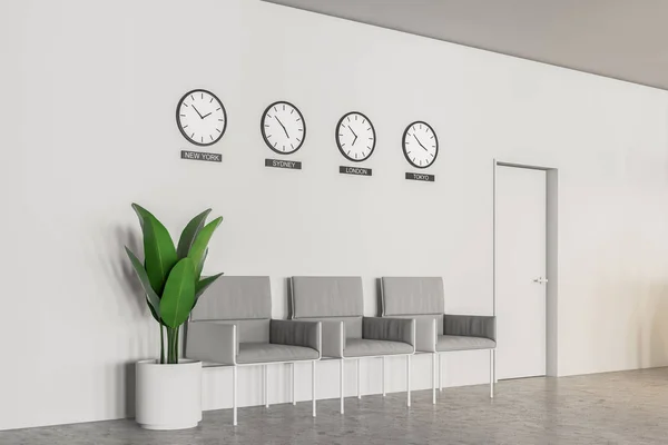 Interior of office or bank waiting room with concrete floor, white walls, row of gray armchairs and clocks with world time. 3d rendering