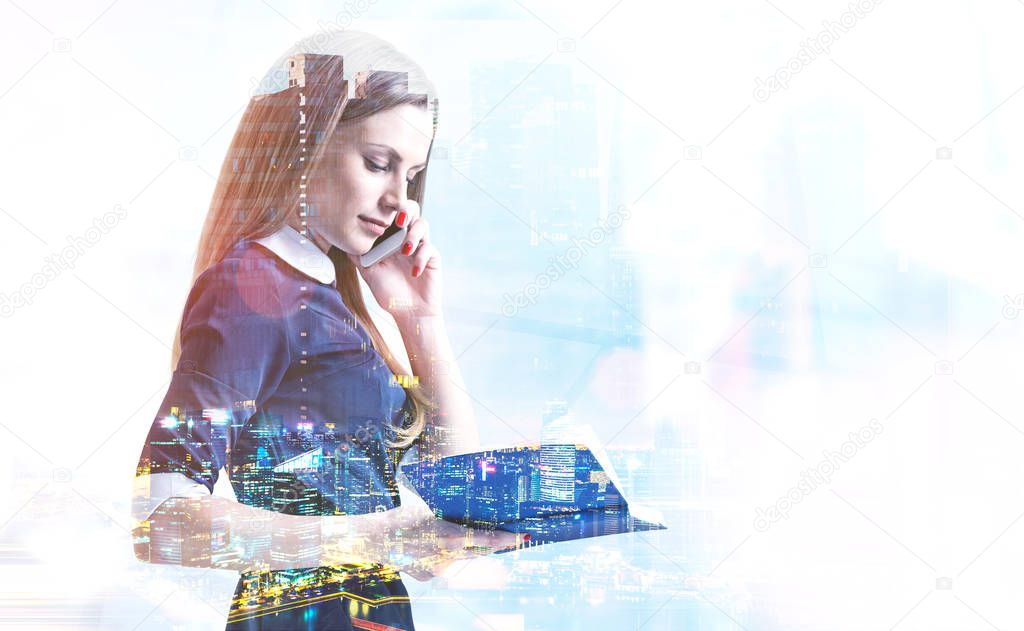 Side view of young businesswoman with long fair hair wearing blue dress talking on phone and looking in her planner. Night cityscape over blurred background. Toned image double exposure mock up
