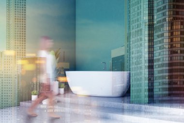 Modern banyo köşede yeşil duvarlar, beton zemin ve merdiven ile beyaz küvet ile yürüyen kadın. Bir tencereye bitki. Tonlu görüntü çift pozlama bulanık