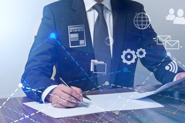 Неузнаваемый бизнесмен, работающий с документами в офисе. Графики, диаграммы и иконки глобальной сети на переднем плане. Тонированное изображение
