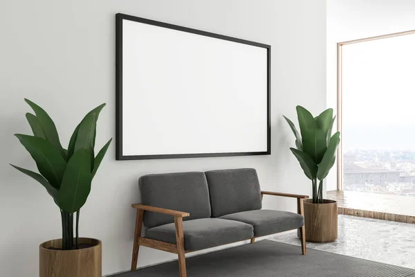 Corner of room with white walls, a honeycomb pattern floor with a carpet on it and gray sofa with horizontal mock up poster frame hanging above it. 3d rendering