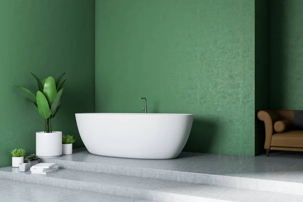 Modern bathroom interior with green walls, concrete floor, white bathtub and a brown sofa. 3d rendering