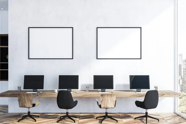 White wall startup office interior with wooden floor, long wooden table with four computer screens on it. Two horizontal mock up poster frames. 3d rendering