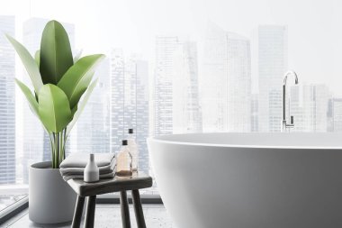 Yuvarlak beyaz küvet duran cityscape panoramik banyo bir beton zemin üzerine kapatın. Saksılı bitki ve şampuanlar sandalyeyle. 3D render