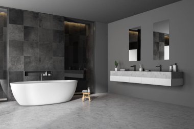 Modern banyo köşesinde siyah kiremit duvarlar, beton zemin, beyaz küvet ve çift lavabo. 3d oluşturma