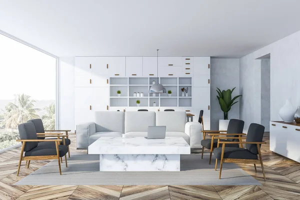 Interior of white living room with white walls, wooden floor, panoramic window, white sofa, gray armchairs and white bookcase. White marble table. 3d rendering