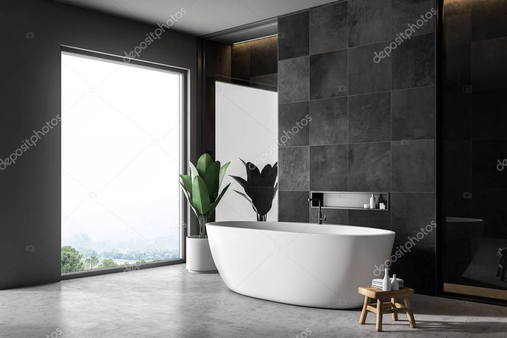 Modern bathroom interior with black tile walls, concrete floor, white bathtub and loft window. 3d rendering