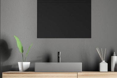 Gri duvar odadaki üstündeki dikdörtgen yansıtmayla ahşap tezgah üzerinde duran gri köşe banyo lavabo. 3D render