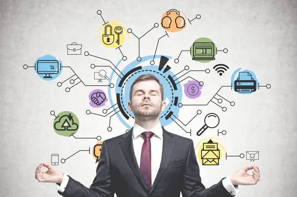 Young Businessman Meditating Concrete Wall Colorful Computer Internet Icons Drawn — Stock Photo, Image