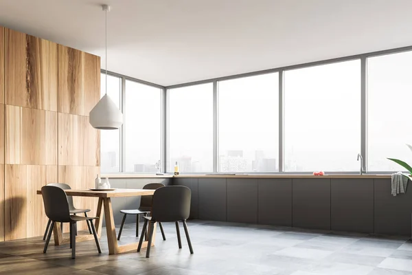 Corner of modern kitchen with panoramic windows, wooden cupboard, gray countertops and wooden table with gray chairs. 3d rendering