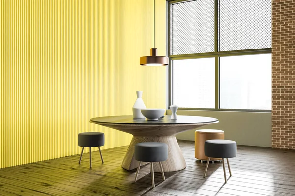 Yellow and brick wall restaurant interior with wooden floor, round table and small gray chairs. 3d rendering