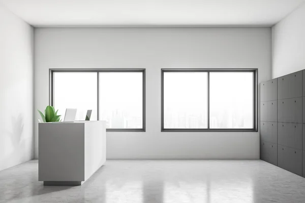 Side view of white reception desk with two laptops on in standing in office of modern company with white walls, concrete floor and row of lockers. 3d rendering
