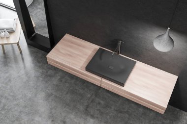 Üstten görünüm siyah duvar ve şık tavan lambası ile odada ahşap tezgah üzerinde duran siyah banyo lavabo. 3D render