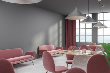 Gri duvarlar, beton zemin, kırmızı sandalye ve duvarın yanında kırmızı koltuklar ile yuvarlak ahşap masa ile modern kafe köşesinde. 3D render